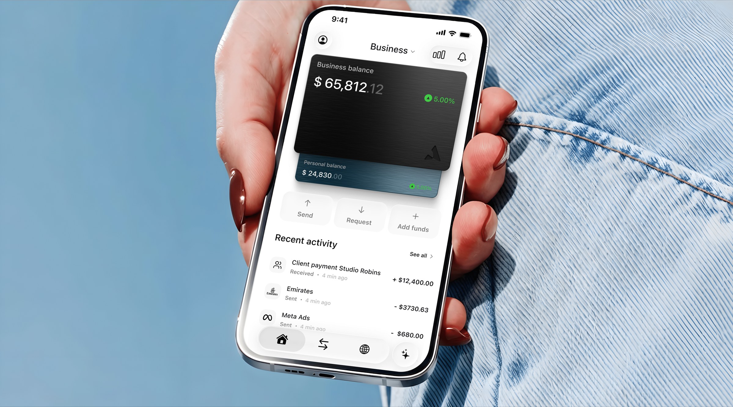 The app held up against the sky, open on a business balance.