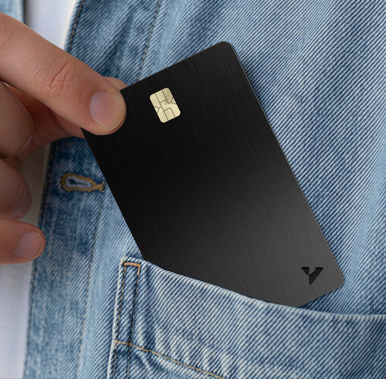 The card going into a jeans pocket.